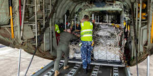 A pallet of humanitarian stores is loaded onto a Royal Australian Air Force C130J Hercules transport aircraft at HMAS Albatross,Nowra,New South Wales.