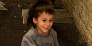 A boy leads the way through the tunnel at Macdonaldtown station.