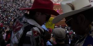 Spectators watch a bullfight at the Plaza Mexico,the largest bullfighting arena in the world.