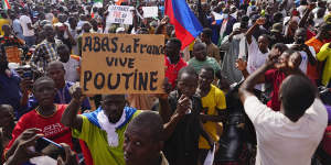 Nigeriens participate in a march called by supporters of coup leader General Abdourahmane Tchiani in Niamey,Niger. The sign reads:“Down with France,long live Putin”.