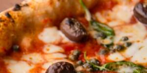 The classic napoletana carries no more than tomato,fior di latte,capers,olives and anchovies.