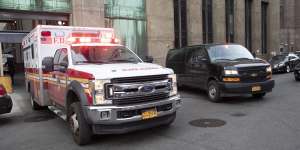 An ambulance carrying Harvey Weinstein is escorted from a Manhattan courthouse.