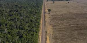 A highway stretching between the Tapajos National Forest,left,and a soy field in Belterra,Para state,Brazil. 