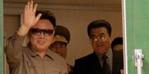 Kim Jong-il waves during a train journey back to North Korea from Russia in 2001.