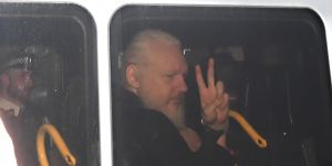 Julian Assange gestures as he arrives at Westminster Magistrates'Court in London.