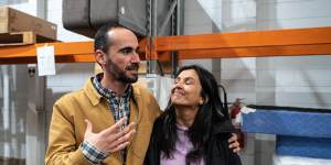 Re-Love employee Mostafa Azimitabar,a Kurdish refugee,left,next to founder Renuka Fernando in the organisation’s Sydney warehouse.