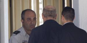Former Israeli prime minister Ehud Olmert enters prison to begin his sentence in the central Israeli town of Ramle,Israel,on Monday.