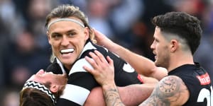 Darcy Moore,Nathan Murphy and Jack Crisp of the Magpies celebrate the win over the Crows,in what was the last round of AFL byes this year.