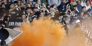 Fans let off flares and smoke bombs at the Melbourne derby match on Saturday.