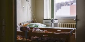 A patient suffering from COVID-19 lays in a bed at a general ward that has been converted to a COVID ward at the hospital in Bochnia,Poland.