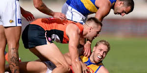 The Giants’ Harry Himmelberg makes sure West Coast forward Oscar Allen isn’t going anywhere.