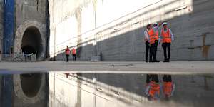 Transport Minister John Graham,left,project director Richard Petaccia and Premier Chris Minns inspect the Burwood North station site on Thursday.