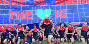 Melbourne captain Max Gawn leads the Demons on the field at the MCG. 