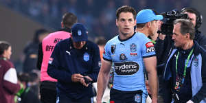NSW’s Cameron Murray is assisted by Blues doctor Nathan Gibbs during game three.