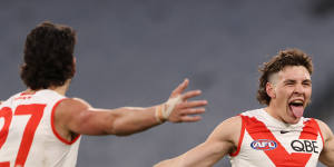 Errol Gulden and the Swans celebrate a goal in round 20.