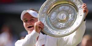 Barbora Krejcikova of Czechia lifts the trophy following victory against Jasmine Paolini of Italy.