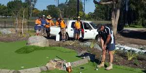 Geoff Bennell tests out one of his mini-golf courses mid-construction.
