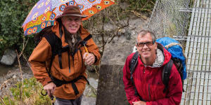 Simon Balderstone,right,and Peter Hillary,with his umbrella on a trek:“It was a joke,but it actually suited him:the perfect gentleman,perfectly attired.”