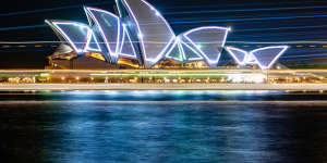 The sails of the Opera House illuminated with lasers on Friday night to celebrate the building’s 50th anniversary.