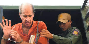 James Ricketson exiting a prison van as he arrived at the Phnom Penh Municipal Court for a court appearance in June,2018. 