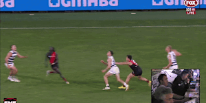 Essendon’s Dylan Shiel pushes Geelong’s Mark O’Connor into a marking contest on Friday night. O’Connor collides with Luamon Lual,who requires a concussion test.