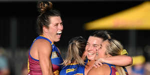 The Brisbane Lions celebrate a famous win.