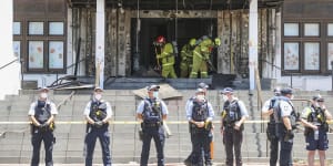 Firefighters responding at the fire-damaged front entrance of Old Parliament House following a protest,in Canberra on Thursday 30 December 2021. fedpol Photo:Alex Ellinghausen