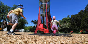 Magnet for kids:Henry and Eloise Gannon shoot towards the rocket play tower in Central Gardens,Hawthorn on Wednesday.