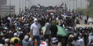 Protesters gather on a bridge leading to the Green Zone area in Baghdad,Iraq,on Saturday.