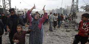 A Palestinian woman gestures following Israeli airstrikes in Khan Younis refugee camp.