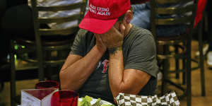 Amy McKinley,a Louisville resident and business owner,reacts during a watch party of the presidential debate.