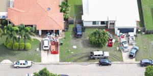 Local residents clean up as floods ease in parts of Townsville on Tuesday.