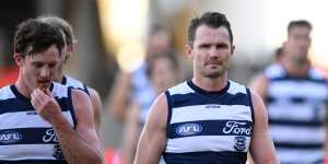 Patrick Dangerfield - flanked by Jed Bews (left) - leads Geelong off the ground after the third successive loss under his fledgling captaincy.