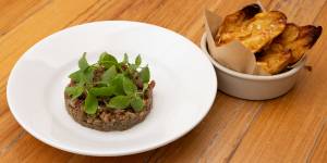 “The beef is beefier here and the Dutch creams are creamier”:Beef tartare with smoked schmaltz and salsa verde served with fried Dutch Cream potatoes.