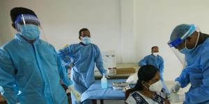 Sri Lankan health workers administer second doses of Sinopharm in Colombo,Sri Lanka in mid June.