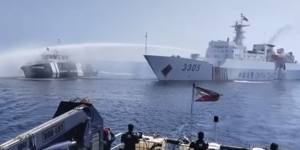 In a video still provided by the Philippine Coast Guard,a Chinese Coast Guard ship (right) uses a water cannon on a Philippine Bureau of Fisheries and Aquatic Resources vessel as it approaches Scarborough Shoal on Saturday.