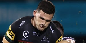 Nathan Cleary is hit hard by Reece Robson after kicking the ball.