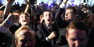 Supporters of French far-right National Rally react at the party election night headquarters earlier this month.
