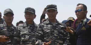 Navy personnel gather around debris recovered from the sea where the Lion Air jet that crashed in the waters of Tanjung Karawang,Indonesia,in November 2018.