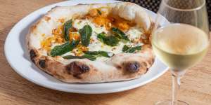 Pizza with pumpkin,stracciatella,pine nuts and fried sage.