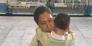 Paige Young with her son at Chatswood Station.