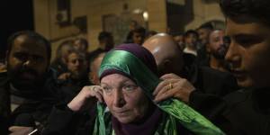 Hanna Barghouti,released by Israeli authorities,wears a Hamas headband on arrival in the West Bank town of Beitunia.
