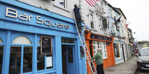 Publicans put up US flags outside the Blue Square bar in Ballina,Ireland.