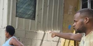 Red Cross volunteers assist locals as they inspect their damaged house in Efate,Vanuatu.