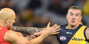 Richmond great Dustin Martin fends off Gold Coast and Geelong champion Dustin Martin.