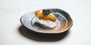 Sea urchin and caviar on transparent crystal bread.