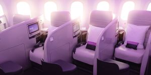 Air New Zealand’s current business class seats on board their Dreamliners:three lengthwise rows of seats with chest-high partitions are angled diagonally into the cabin.