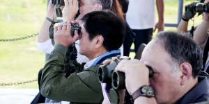 Watching out for trouble in the South China Sea:Australian Defence Minister Richard Marles,left,and Philippine President Ferdinand Marcos jnr,centre,watch the combined amphibious assault exercise on Friday.