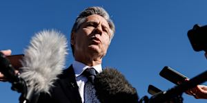 US Secretary of State Antony Blinken talks to reporters prior to boarding.