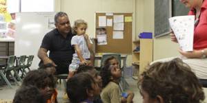 Watch and learn … Pearson with his son,Charlie,on his lap,at the Cape York Aboriginal Australian Academy,Aurukun campus,in 2010.